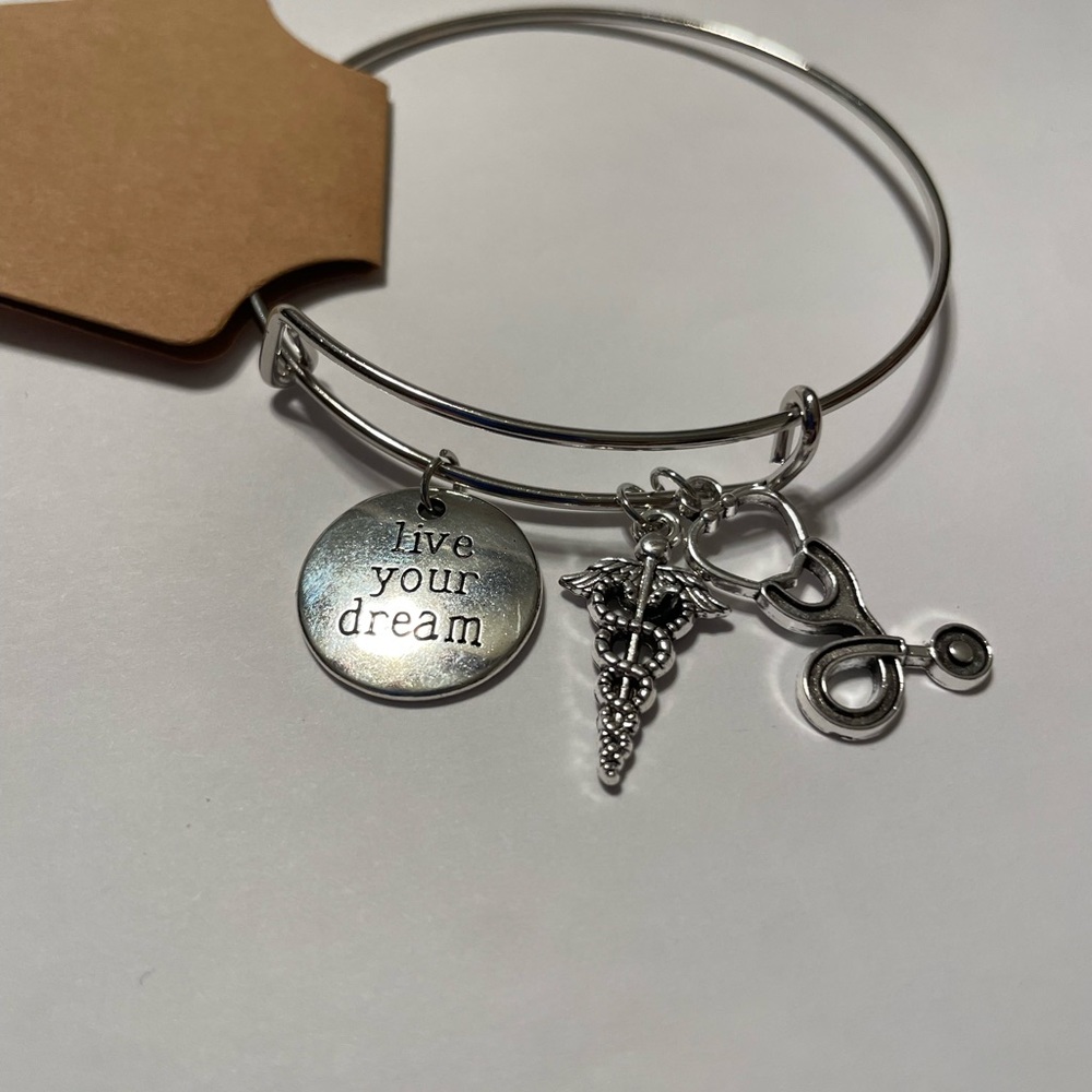 Silver expandable bracelet with charms.